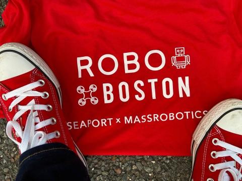 Red sneakers standing over Robo Boston logos
